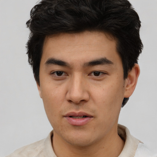 Joyful asian young-adult male with short  black hair and brown eyes