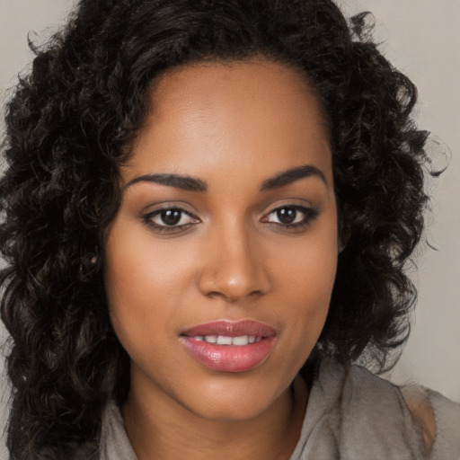 Joyful latino young-adult female with long  brown hair and brown eyes