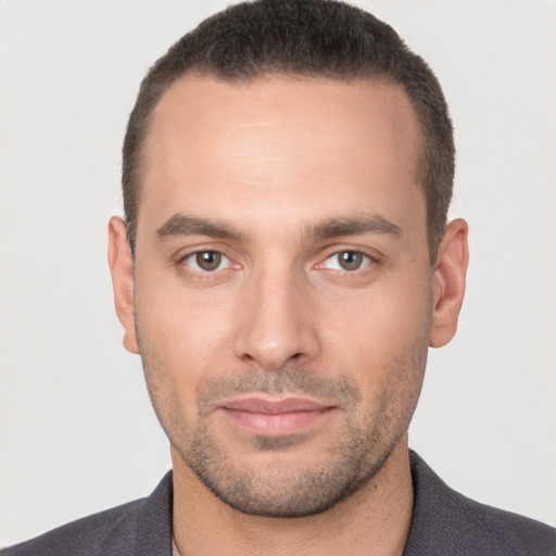 Joyful white young-adult male with short  brown hair and brown eyes