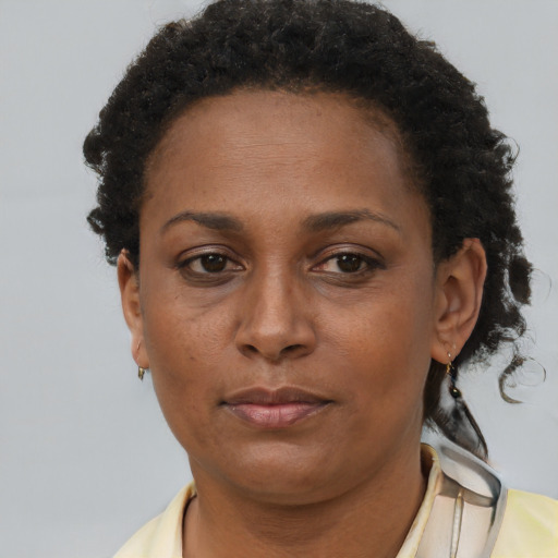 Neutral black adult female with short  brown hair and brown eyes