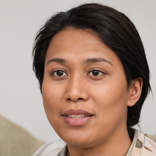Joyful asian adult female with medium  brown hair and brown eyes