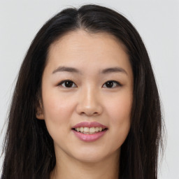 Joyful asian young-adult female with long  brown hair and brown eyes