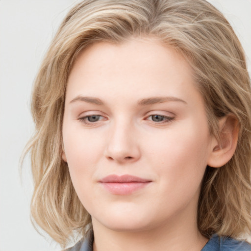 Joyful white young-adult female with long  brown hair and blue eyes