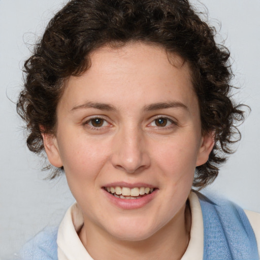 Joyful white young-adult female with medium  brown hair and blue eyes