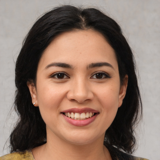 Joyful latino young-adult female with medium  black hair and brown eyes