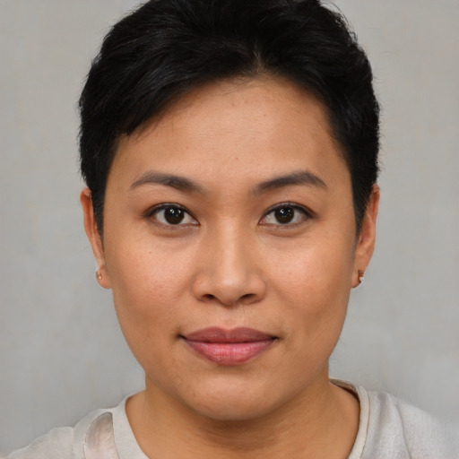 Joyful asian young-adult female with short  brown hair and brown eyes