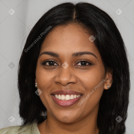 Joyful black young-adult female with long  brown hair and brown eyes