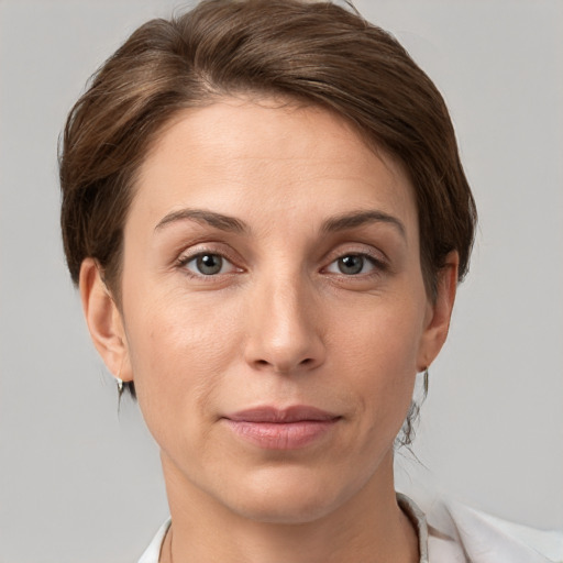 Joyful white young-adult female with short  brown hair and grey eyes