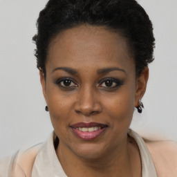 Joyful black young-adult female with short  black hair and brown eyes