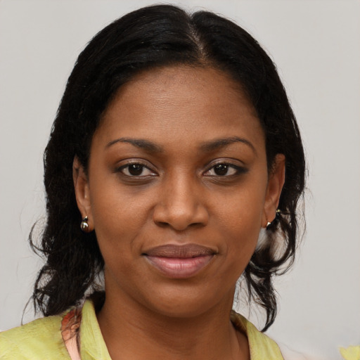 Joyful black young-adult female with medium  brown hair and brown eyes