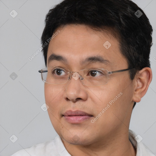 Joyful asian young-adult male with short  brown hair and brown eyes