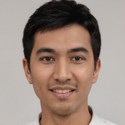 Joyful asian young-adult male with short  black hair and brown eyes