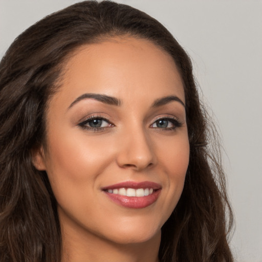 Joyful white young-adult female with long  brown hair and brown eyes