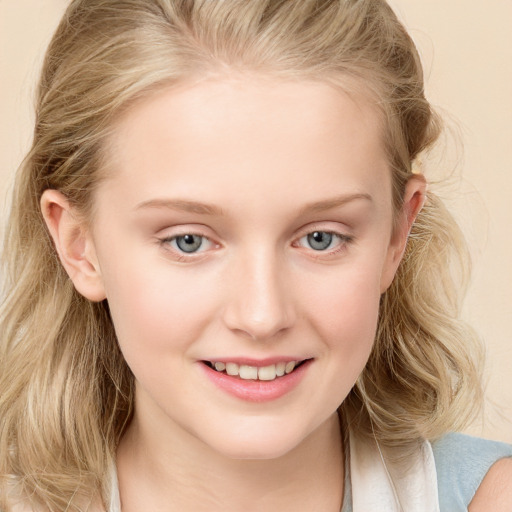 Joyful white child female with long  brown hair and blue eyes