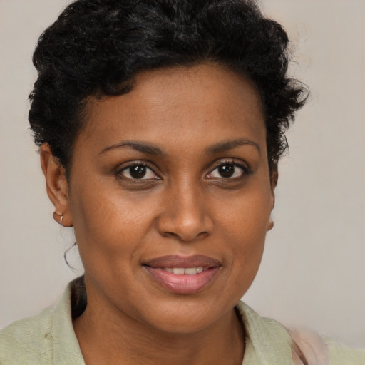 Joyful black young-adult female with short  brown hair and brown eyes