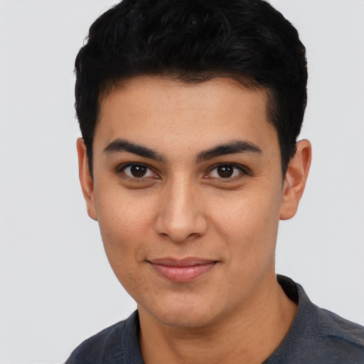 Joyful asian young-adult male with short  black hair and brown eyes