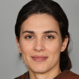 Joyful white adult female with medium  brown hair and brown eyes