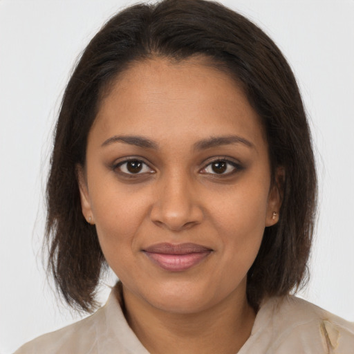 Joyful black young-adult female with medium  brown hair and brown eyes