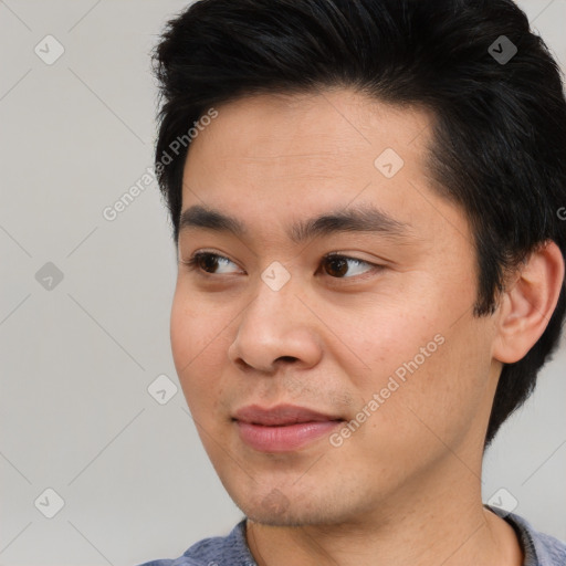 Joyful asian young-adult male with short  black hair and brown eyes