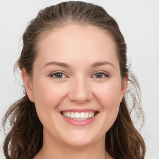 Joyful white young-adult female with long  brown hair and grey eyes