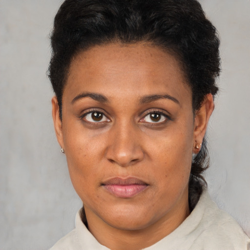Joyful black adult female with short  brown hair and brown eyes