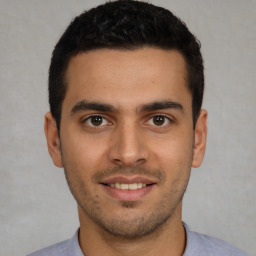 Joyful white young-adult male with short  black hair and brown eyes