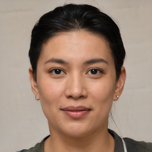 Joyful white young-adult female with short  black hair and brown eyes
