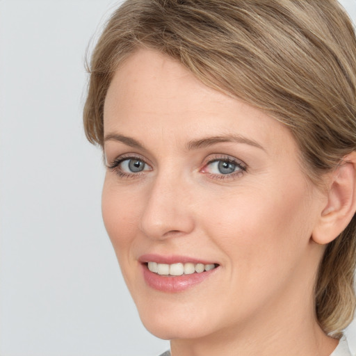 Joyful white young-adult female with long  brown hair and blue eyes