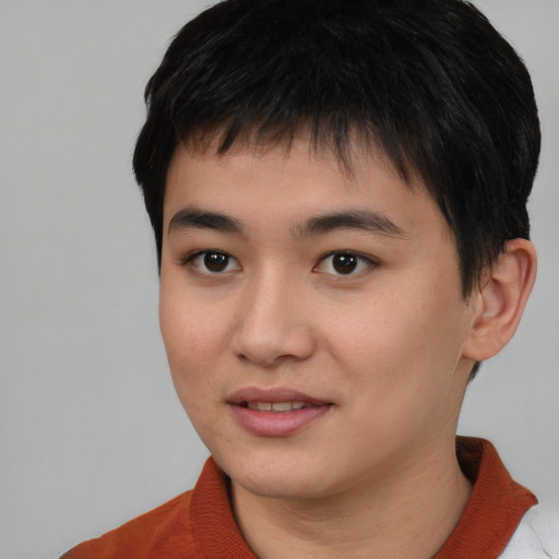 Joyful asian young-adult male with short  black hair and brown eyes