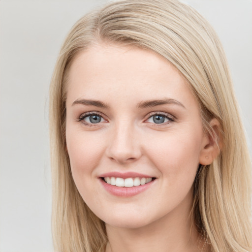 Joyful white young-adult female with long  brown hair and blue eyes