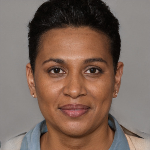 Joyful black adult female with short  black hair and brown eyes