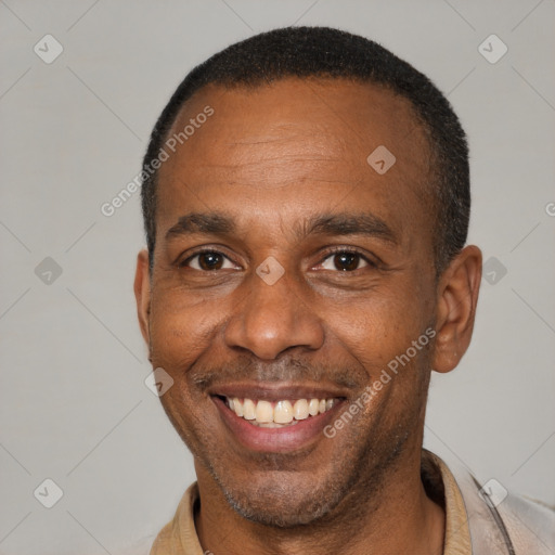 Joyful latino adult male with short  brown hair and brown eyes
