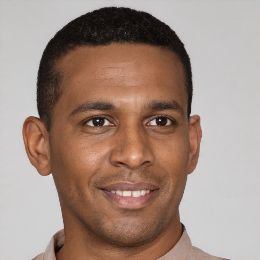 Joyful latino young-adult male with short  brown hair and brown eyes