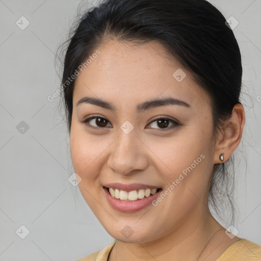 Joyful asian young-adult female with medium  brown hair and brown eyes