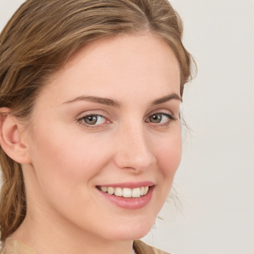 Joyful white young-adult female with medium  brown hair and blue eyes