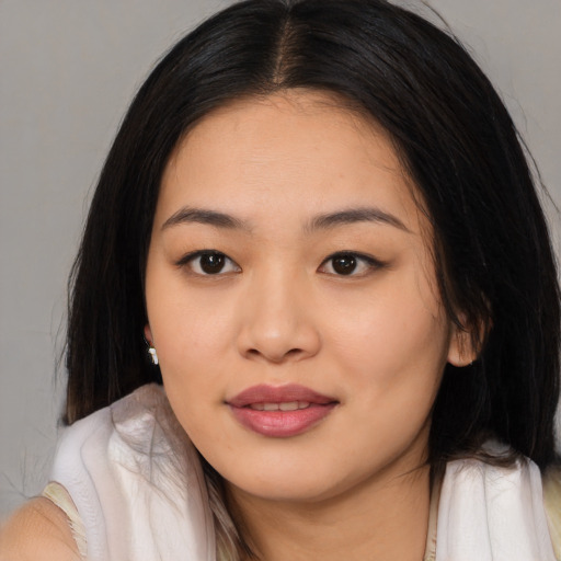 Joyful asian young-adult female with long  black hair and brown eyes
