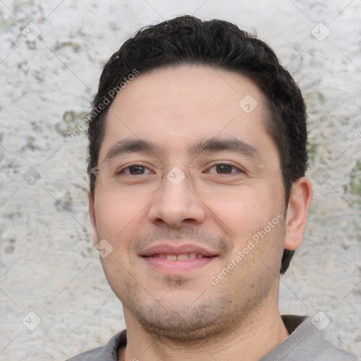 Joyful white young-adult male with short  black hair and brown eyes