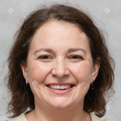 Joyful white adult female with medium  brown hair and grey eyes