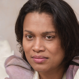 Joyful white adult female with medium  brown hair and brown eyes