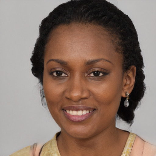 Joyful black adult female with medium  black hair and brown eyes