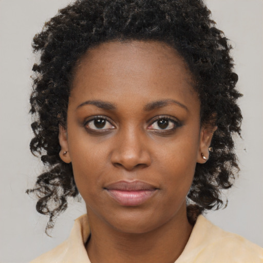 Neutral black young-adult female with long  brown hair and brown eyes