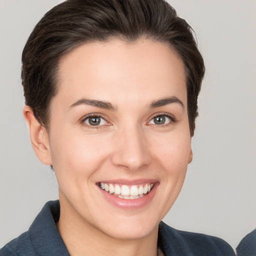 Joyful white young-adult female with short  brown hair and brown eyes