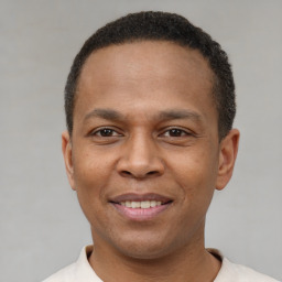 Joyful latino young-adult male with short  brown hair and brown eyes
