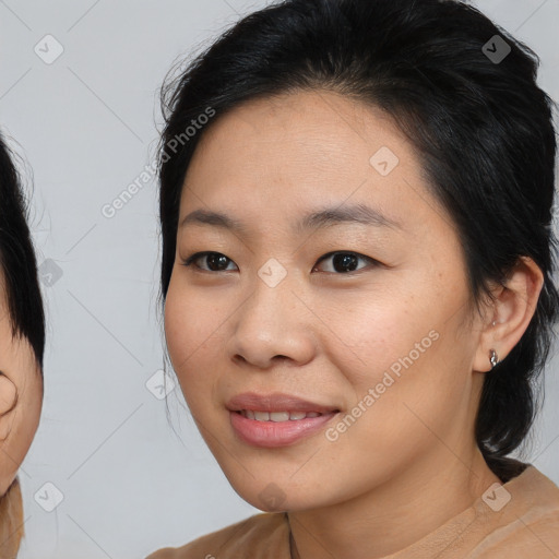 Joyful asian young-adult female with medium  brown hair and brown eyes