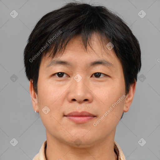 Joyful asian adult male with short  brown hair and brown eyes