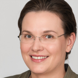 Joyful white adult female with medium  brown hair and grey eyes