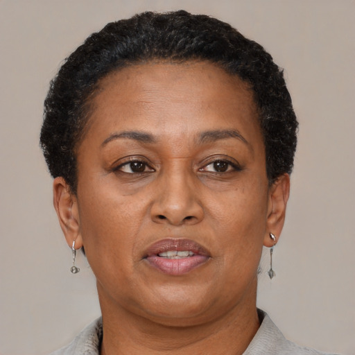 Joyful black adult female with short  brown hair and brown eyes