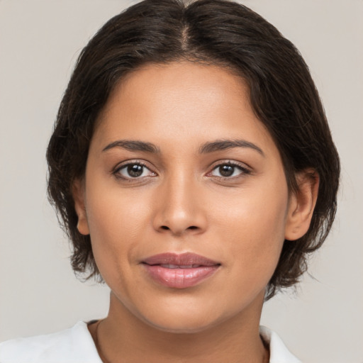 Joyful white young-adult female with medium  brown hair and brown eyes