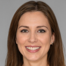 Joyful white adult female with long  brown hair and brown eyes