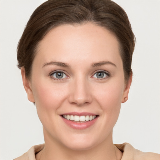 Joyful white young-adult female with short  brown hair and grey eyes